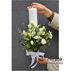 White christening candle with natural flowers